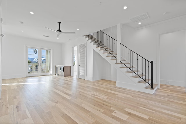 unfurnished living room featuring ceiling fan and light wood-type flooring