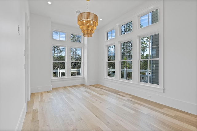 unfurnished sunroom featuring a notable chandelier