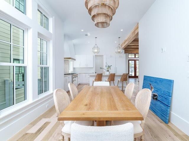 dining area with recessed lighting, baseboards, an inviting chandelier, and light wood-style floors