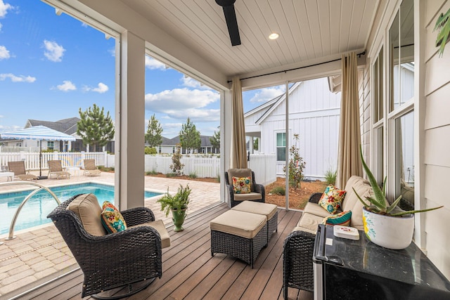 sunroom / solarium featuring ceiling fan and wood ceiling