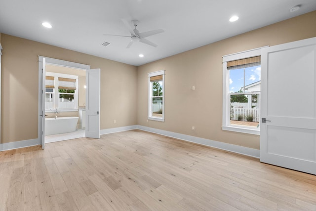 interior space featuring multiple windows, ceiling fan, and light hardwood / wood-style floors