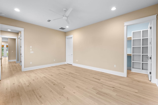 spare room with light wood-type flooring and ceiling fan