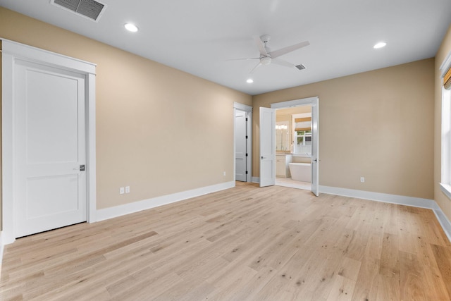 empty room with ceiling fan and light hardwood / wood-style floors