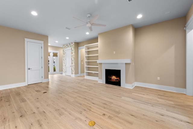 unfurnished living room featuring light hardwood / wood-style floors and ceiling fan