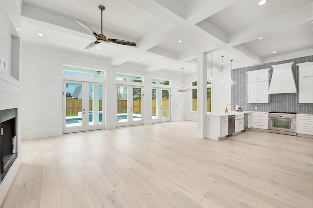 kitchen with premium range hood, french doors, light hardwood / wood-style flooring, beamed ceiling, and white cabinetry