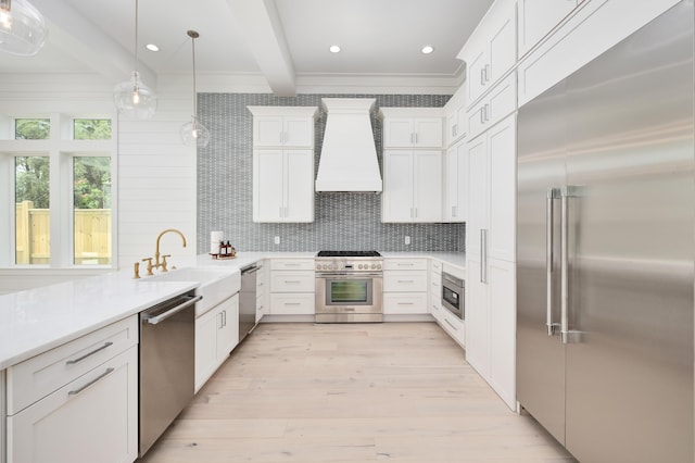 kitchen with built in appliances, beam ceiling, light wood-type flooring, and premium range hood