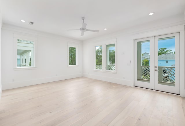 spare room with french doors, light hardwood / wood-style flooring, ceiling fan, and ornamental molding