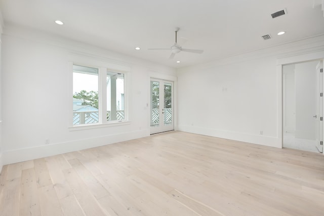 empty room featuring ceiling fan, crown molding, and light hardwood / wood-style flooring