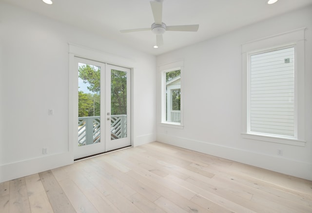 empty room with ceiling fan, french doors, and light wood-type flooring