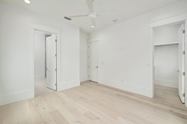 unfurnished bedroom with a closet, ceiling fan, and light hardwood / wood-style flooring