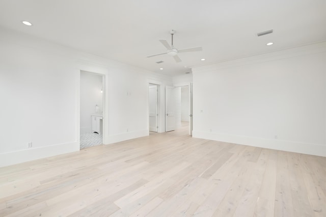 spare room featuring light hardwood / wood-style flooring, ceiling fan, and crown molding