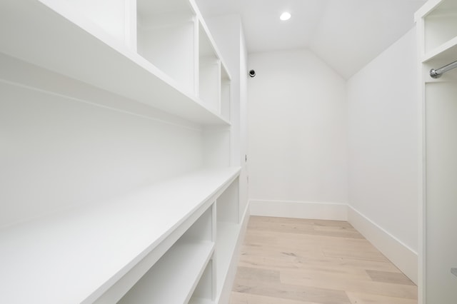 interior space with light hardwood / wood-style floors and lofted ceiling