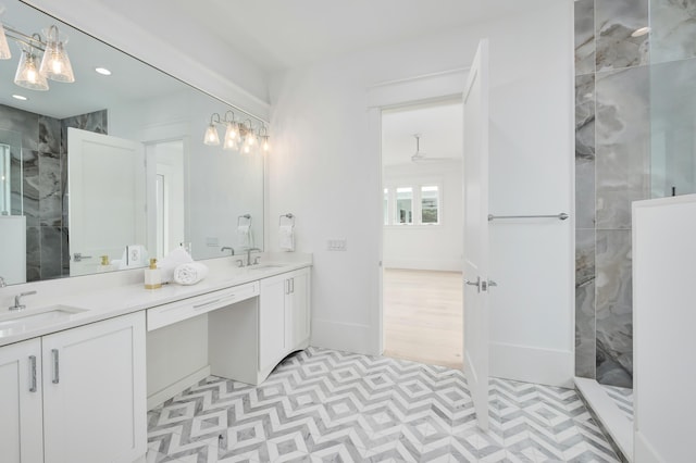 bathroom with vanity and tiled shower