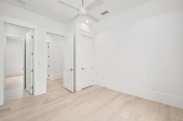 unfurnished bedroom with ceiling fan and light hardwood / wood-style floors