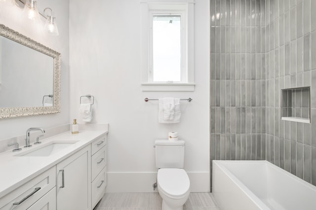 full bathroom with tile patterned flooring, vanity, tiled shower / bath combo, and toilet