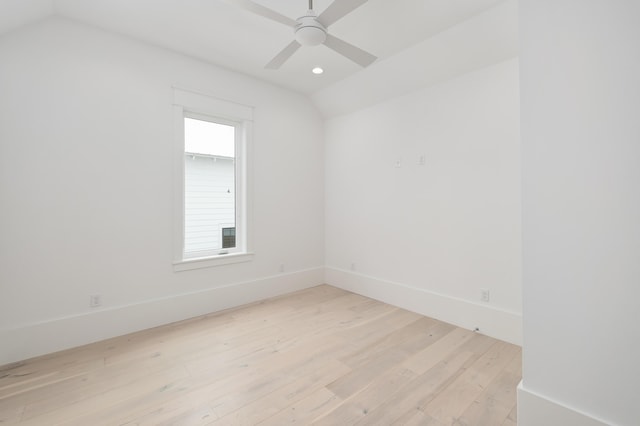 empty room featuring light wood-type flooring, vaulted ceiling, and ceiling fan