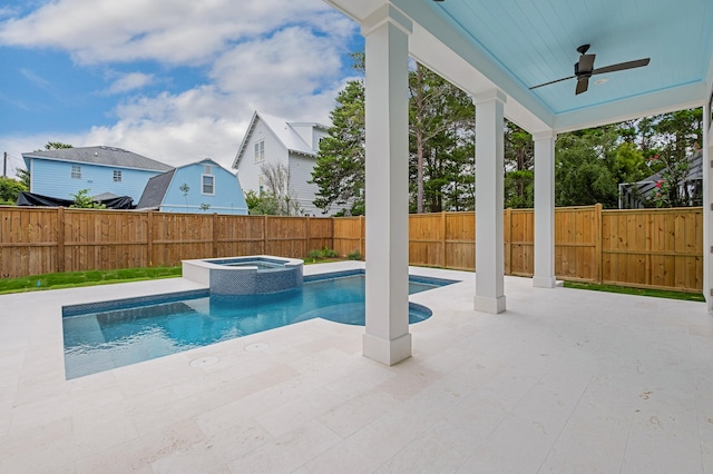 view of swimming pool featuring ceiling fan, a patio area, and an in ground hot tub