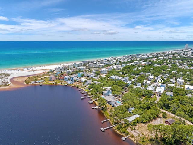 aerial view with a water view and a beach view