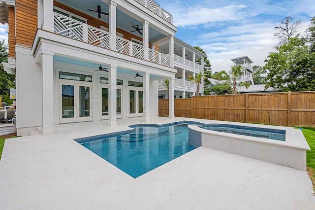 view of pool with a patio area, an in ground hot tub, french doors, and ceiling fan