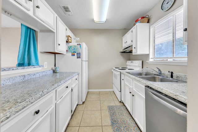 kitchen with light tile patterned floors, white cabinetry, sink, and white appliances
