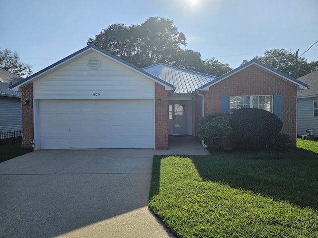 ranch-style house featuring concrete driveway, a garage, a front yard, and brick siding