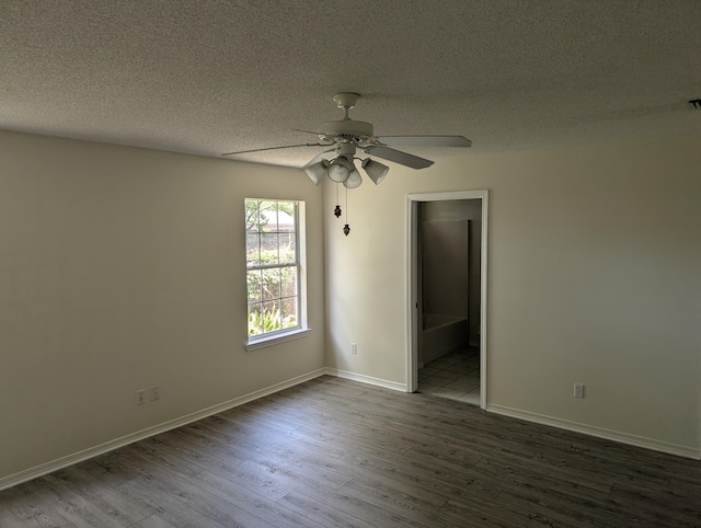 unfurnished room featuring ceiling fan, a textured ceiling, baseboards, and wood finished floors