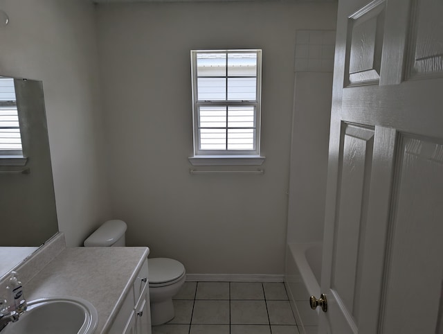 full bath with a bath, baseboards, toilet, vanity, and tile patterned flooring