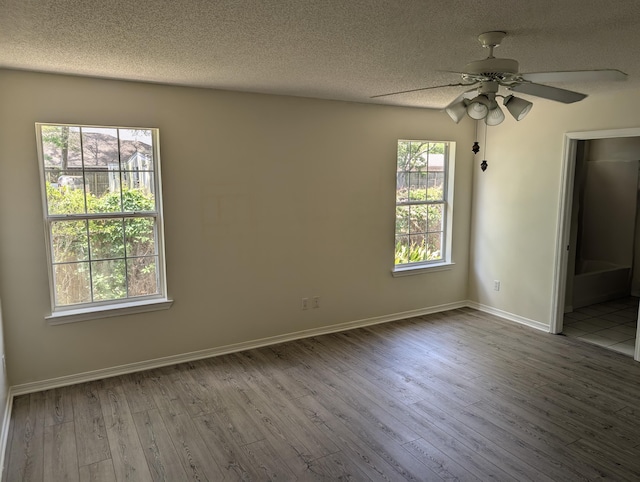 unfurnished bedroom with baseboards, ceiling fan, wood finished floors, and a textured ceiling