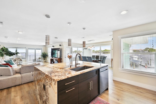 kitchen featuring dark brown cabinetry, dishwasher, sink, and light hardwood / wood-style flooring