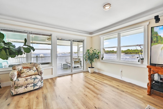 sitting room featuring light wood-type flooring and ornamental molding