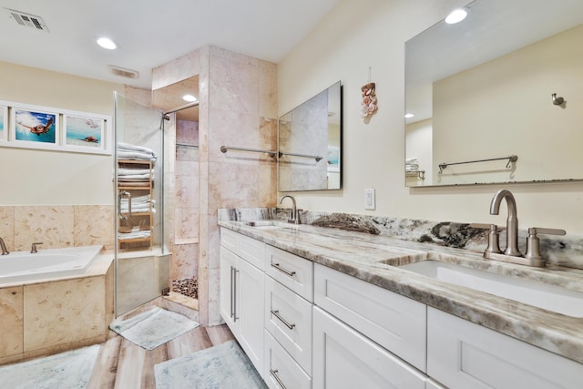 bathroom featuring vanity, separate shower and tub, and wood-type flooring