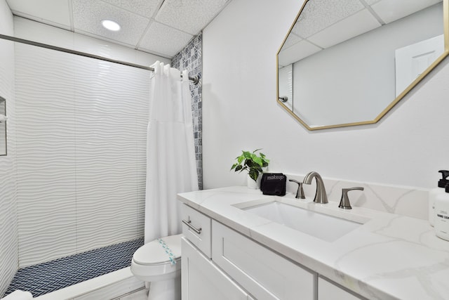 bathroom featuring a shower with curtain, vanity, toilet, and a paneled ceiling