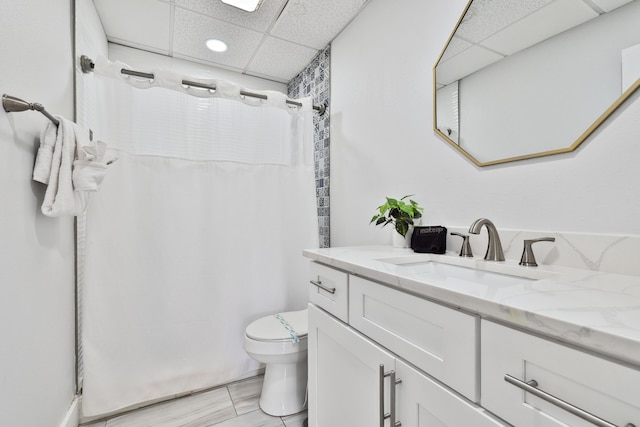 bathroom with a paneled ceiling, vanity, a shower with curtain, tile patterned flooring, and toilet