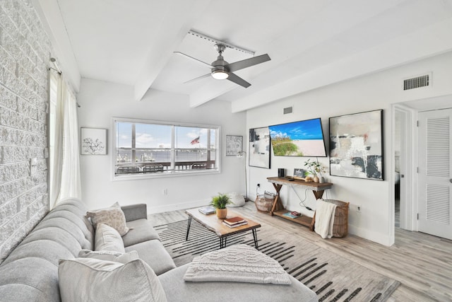 living room featuring beamed ceiling, wood-type flooring, and ceiling fan