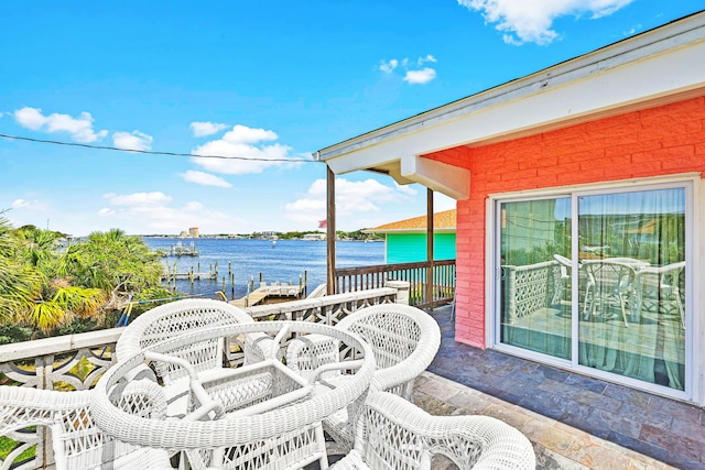 view of patio featuring a boat dock and a water view