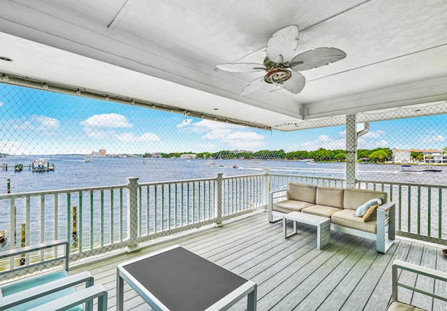 deck featuring outdoor lounge area, a water view, and ceiling fan