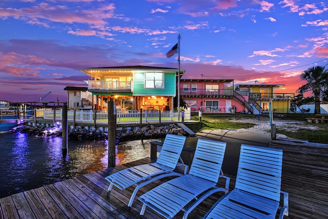 view of dock featuring a water view and a balcony