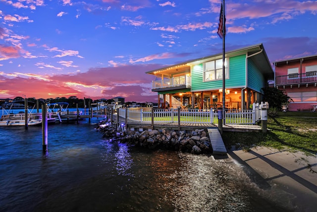 view of dock with a water view and a balcony