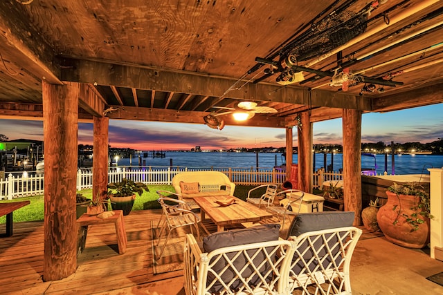 patio terrace at dusk with a deck with water view