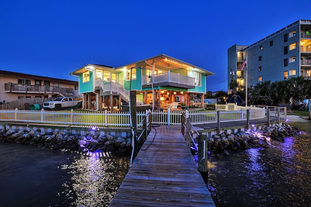 view of dock featuring a balcony and a water view