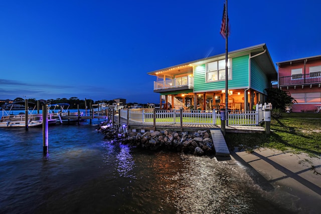 dock area featuring a balcony and a water view