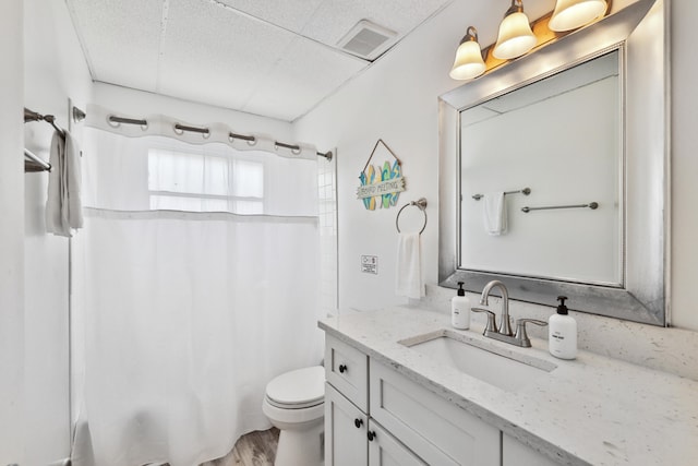 full bathroom featuring vanity, toilet, wood-type flooring, and shower / tub combo with curtain