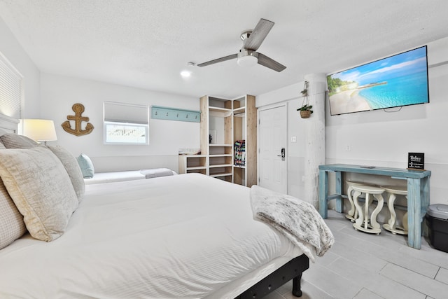 bedroom with ceiling fan, a closet, and a textured ceiling