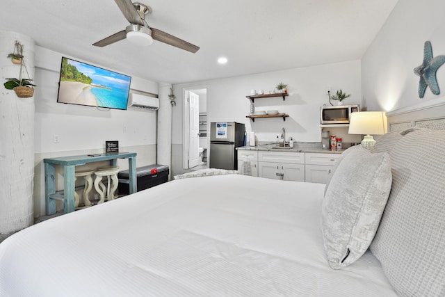 bedroom featuring ceiling fan, stainless steel fridge, sink, and a wall unit AC