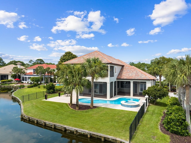 back of house featuring a water view, a pool with hot tub, a sunroom, and a patio area