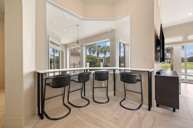 kitchen with light parquet floors and crown molding