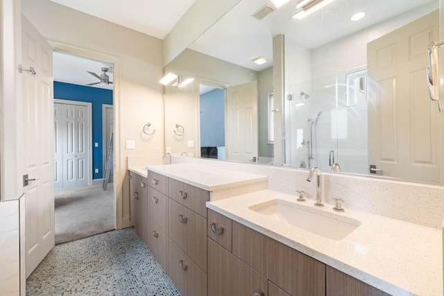 bathroom featuring vanity, a shower with shower door, and ceiling fan