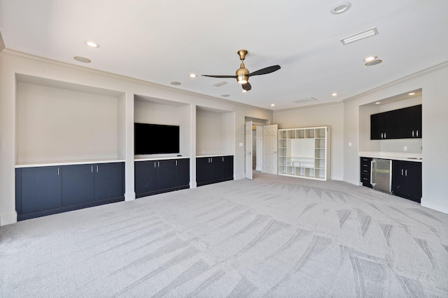 unfurnished living room featuring crown molding, ceiling fan, and light carpet