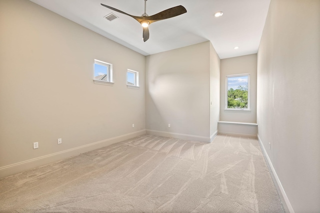 carpeted spare room with ceiling fan