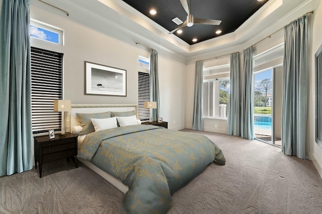 bedroom with light carpet, access to outside, ceiling fan, and a tray ceiling